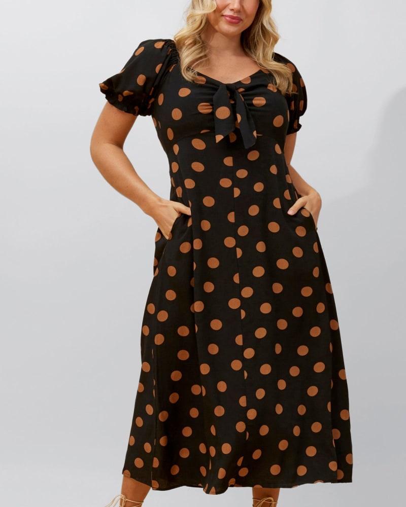 Front of a model wearing a size 1X Elena Midi Dress Polka Dot Front Tie Black in Black by ANNICK. | dia_product_style_image_id:352568